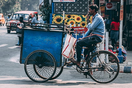 man riding on blue cart thumbnail
