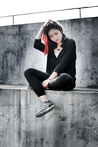 woman wearing black hoodie and touching her hair thumbnail