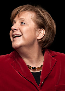 woman wearing red blazer smiling with black background thumbnail
