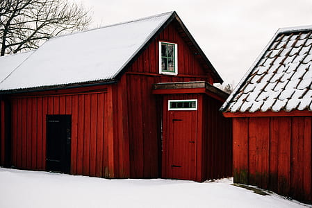 brown wooden houses during snow thumbnail