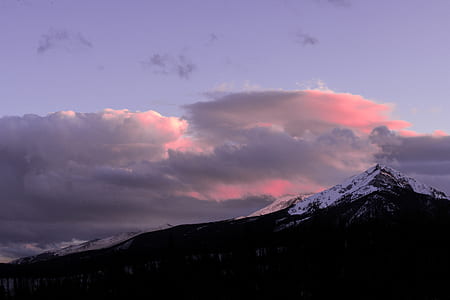 snow covered mountain under white cloudy sky at daytime thumbnail