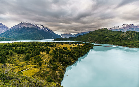body of water near mountains thumbnail