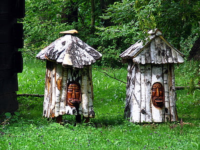 two brown wooden houses near trees thumbnail