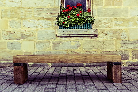 brown wooden bench near window thumbnail