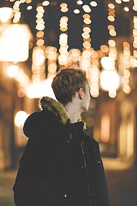 selective focus photo of man facing back with bokeh thumbnail