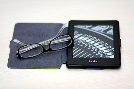 black framed eyeglasses on black Amazon Kindle Fire with case thumbnail