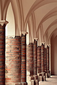 brown brick and white concrete columns thumbnail