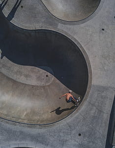 topless man riding skateboard at skate park thumbnail