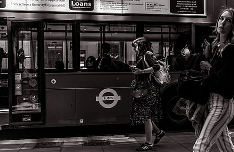 woman in black long-sleeved dress walking on the street thumbnail