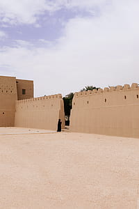 person standing beside brown wall thumbnail