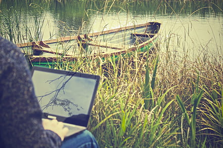 person holding grey laptop computer thumbnail
