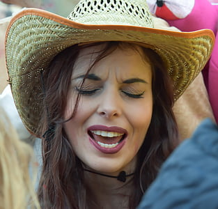 woman in brown sunhat surrounded by people thumbnail