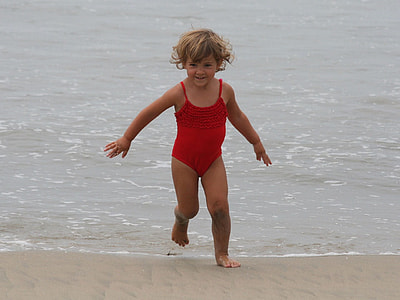 girl in red swimsuit running on body of water thumbnail