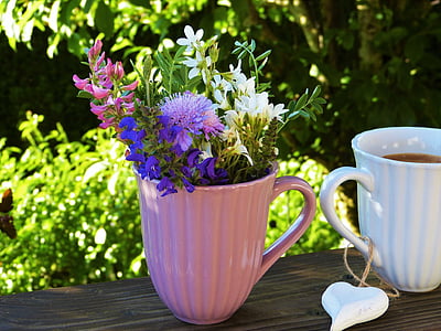 flowers in beige ceramic pot thumbnail