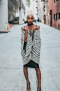 woman standing in the middle of street holding her cardigan thumbnail