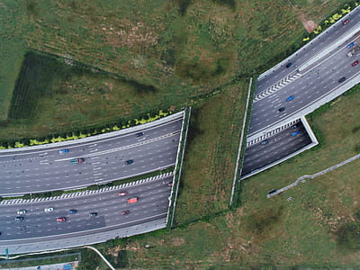 bird's-eye view photography of cars passing through highway thumbnail