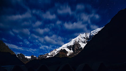 time lapse photography ogf mountain alps under cumulus clouds thumbnail