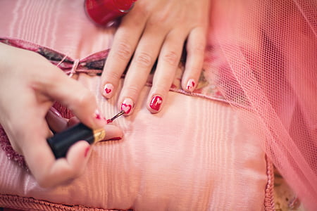 person holding black nail polish brush thumbnail