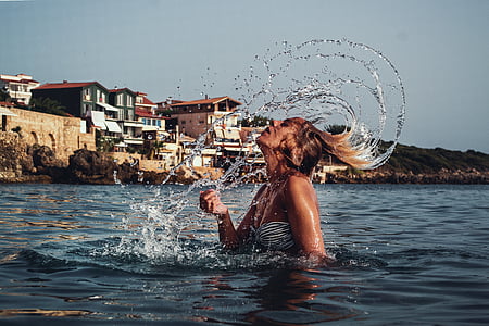woman on body of water during daytime thumbnail