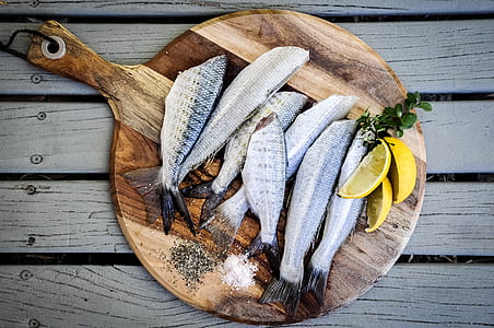salmon fish on chopping board beside salt and pepper thumbnail