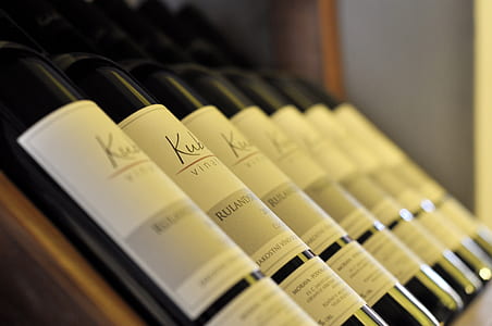pile of wine bottles selective focus photography thumbnail