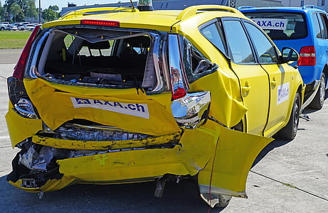 wrecked yellow 5-door hatchback parked in front of blue vehicle at daytime thumbnail