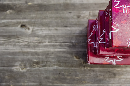 three red tree print boxes on gray wooden board thumbnail