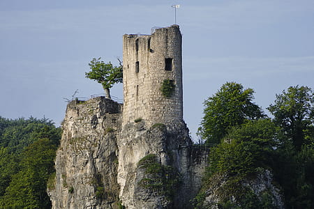 gray concrete building surrounded by green leafed trees during daytime thumbnail