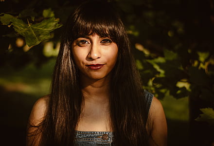 selective focus photography of woman under green leaf plant at daytime thumbnail