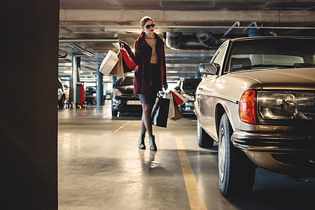 woman wearing red cardigan carrying paper bags thumbnail
