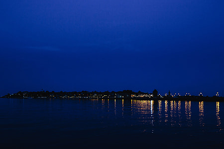 City lights reflected in the water at night thumbnail