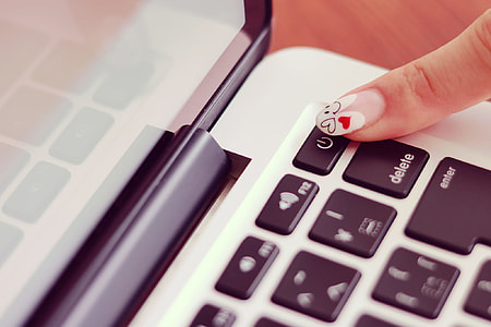 person pointing black and gray laptop power button thumbnail