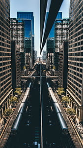 aerial photography of train near buildings during daytime thumbnail