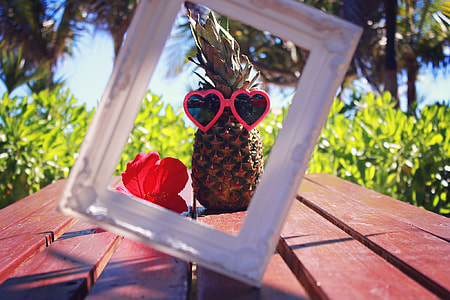 selective focus photo of pineapple with pink framed heart shape sunglasses thumbnail