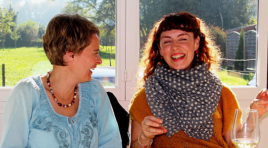 two laughing women in well lit room thumbnail