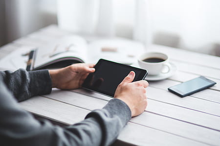 person holding black tablet computer thumbnail