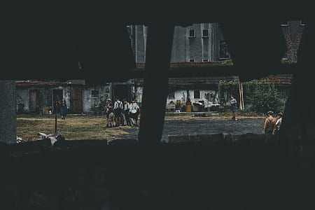 photo of men standing front of house thumbnail