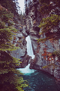 fountain surrounding by rock formations thumbnail