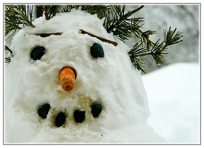 snowman with carrot nose under pine tree thumbnail