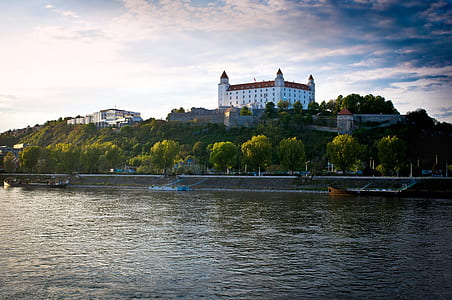 white concrete castle near river at daytime thumbnail