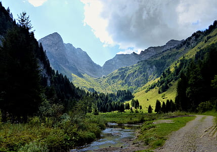 landscape photography of green mountains under cloudy sky at daytime thumbnail