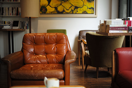 tufted empty brown leather sofa chair thumbnail