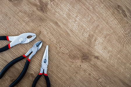 Set of pliers tools on wooden board thumbnail
