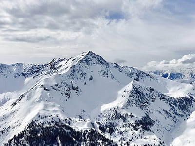 snow covered mountains under white cloudy sky thumbnail