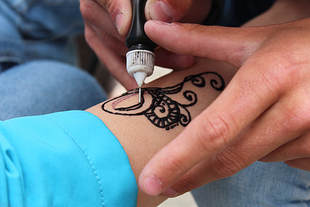 person doing tattoo on arm thumbnail