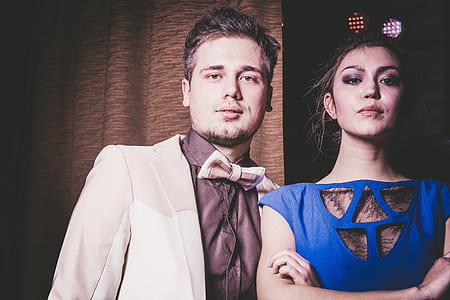 man standing beside woman wearing blue dress thumbnail