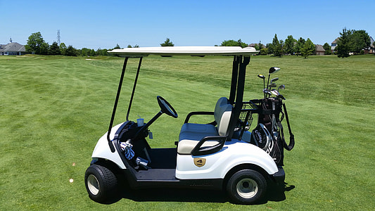 white and black golf cart on golf course thumbnail
