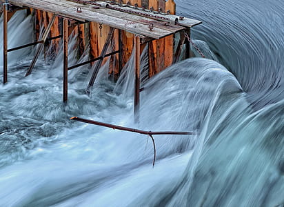 time-lapse photography of brown dock and splash of water thumbnail