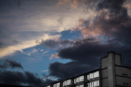building under black sky thumbnail