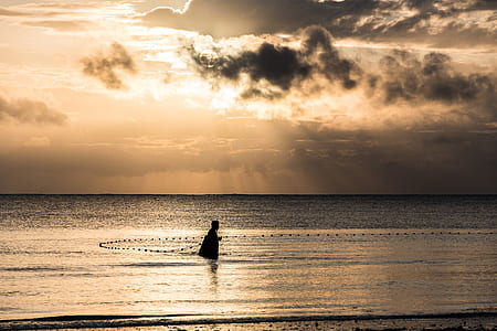 person walking on body of water photo thumbnail